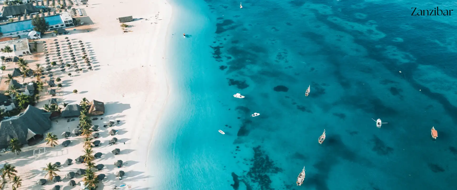 Aerial view of Zanzibar beach with traditional boats