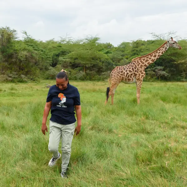 Jacqueline on walking safari with giraffe in Arusha National Park - local expertise and authentic experiences