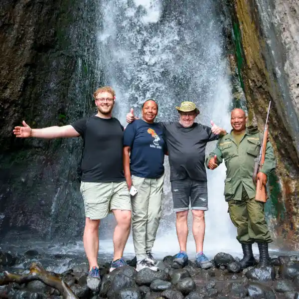 Safari tourists planning their Tanzania adventure at Ngorongoro Crater viewpoint